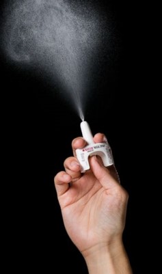 a hand spraying Narcan showcasing the spray power.